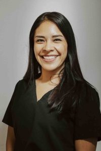 Woman in black scrubs smiling in headshot